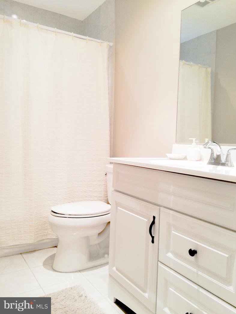 7512 Labyrinth Road Pikesville, MD 21208 - Photo 18 of 24 a bathroom with a sink and a toilet