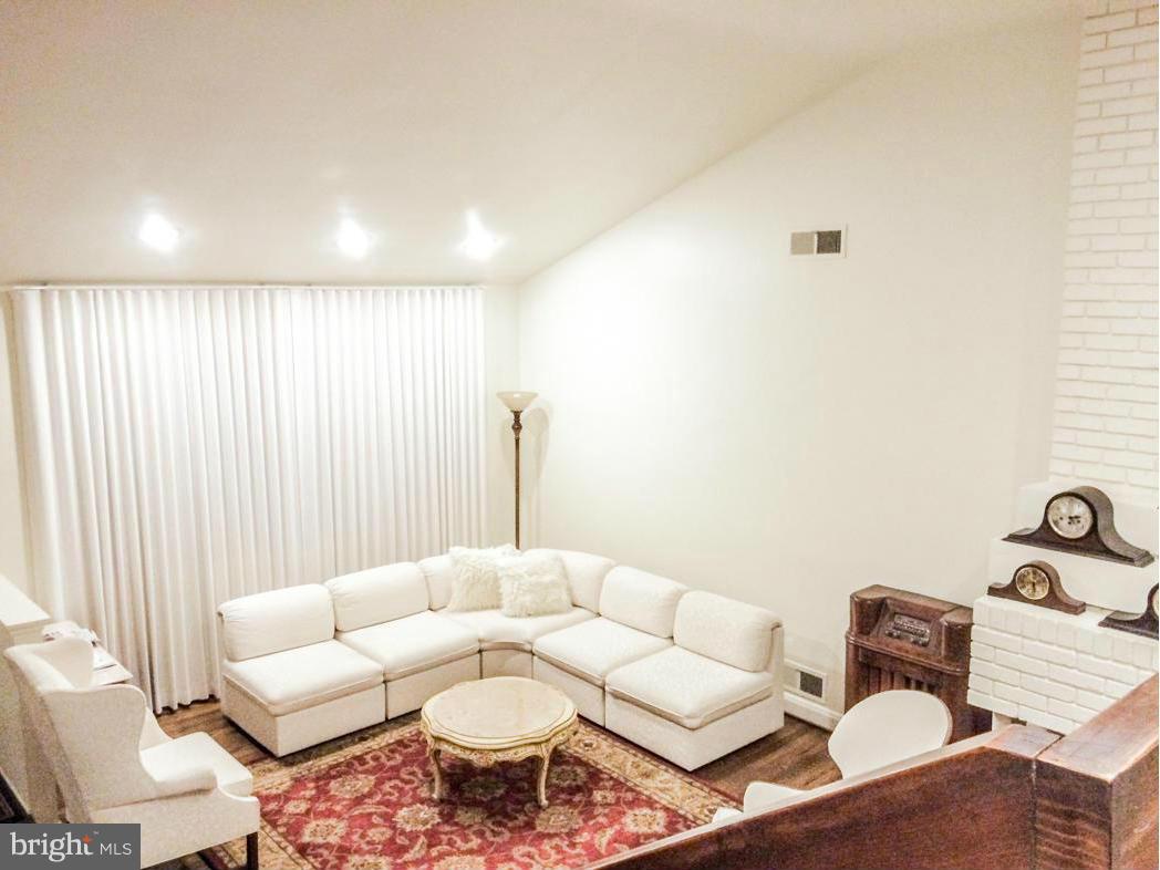 7512 Labyrinth Road Pikesville, MD 21208 - Photo 8 of 24 a living room with furniture and a large window