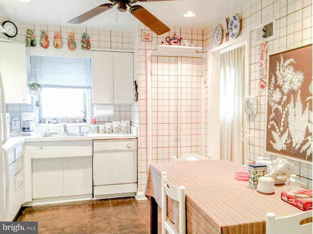 7512 Labyrinth Road Pikesville, MD 21208 - Photo 10 of 24 a kitchen with a stove a sink and a refrigerator