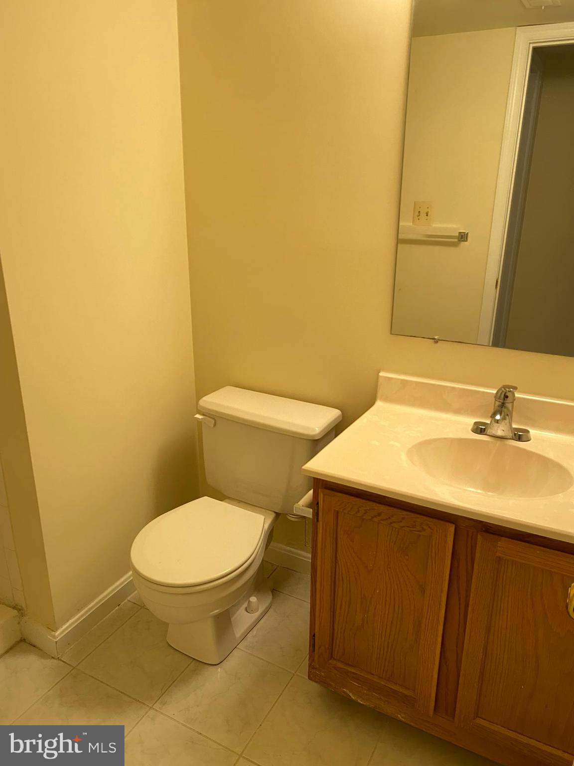 9006 Pickwick Village Terrace Silver Spring, MD 20901 - Photo 4 of 13 a bathroom with a sink toilet and mirror