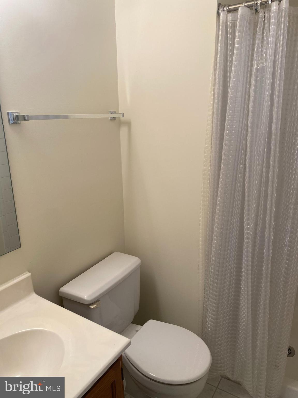 9006 Pickwick Village Terrace Silver Spring, MD 20901 - Photo 10 of 13 a white toilet sitting next to a small sink