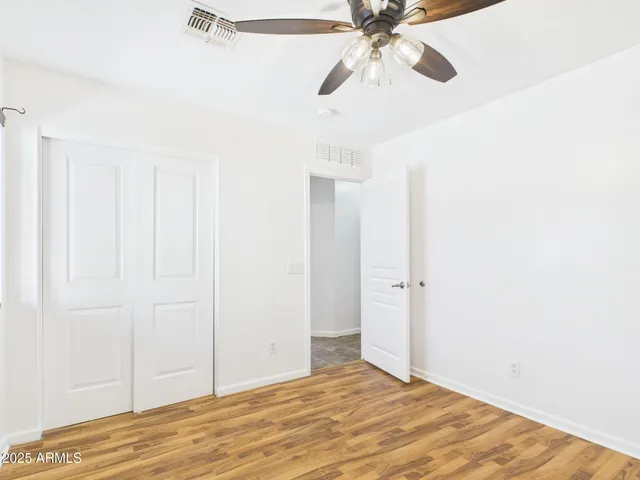 a view of a room with a ceiling fan
