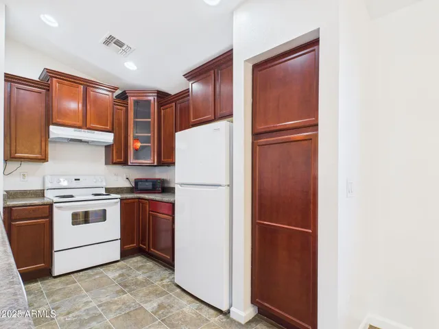 a kitchen with stainless steel appliances granite countertop a refrigerator stove a sink and dishwasher