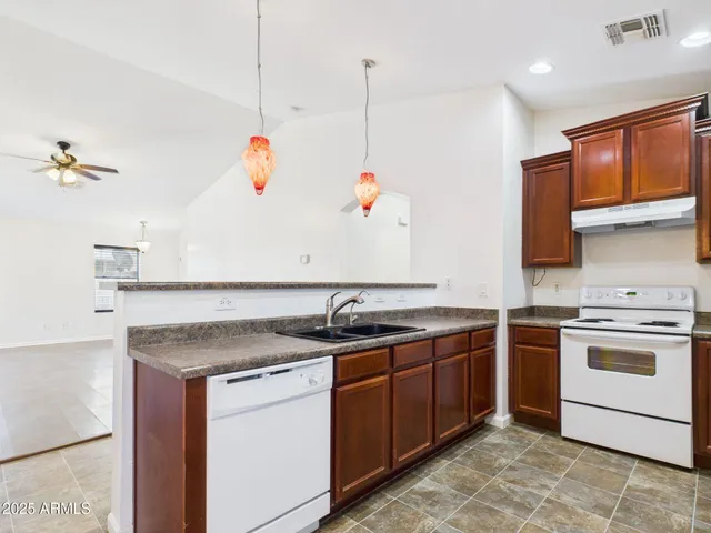 a kitchen with a sink and a stove