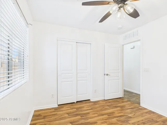 a view of a room with a ceiling fan
