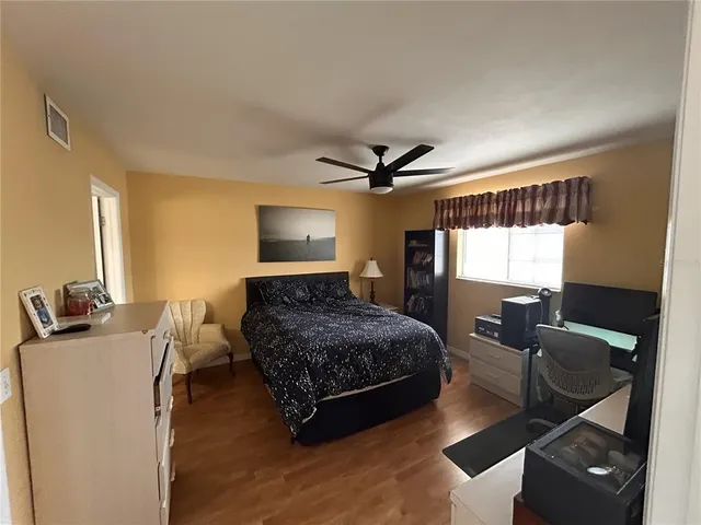 a spacious bathroom with a double vanity sink toilet and a mirror