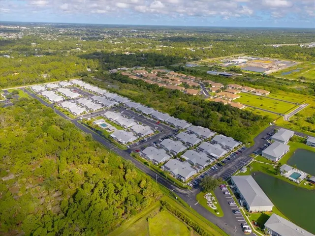 an aerial view of a house with a yard basket ball court and outdoor seating