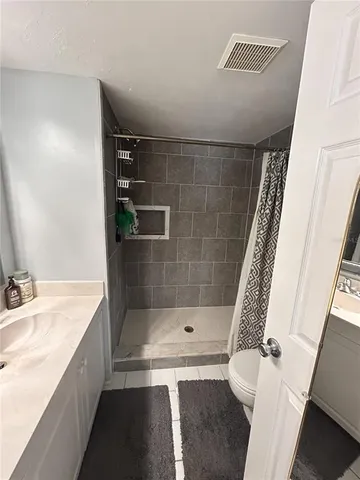 a bathroom with a sink a mirror and a shower