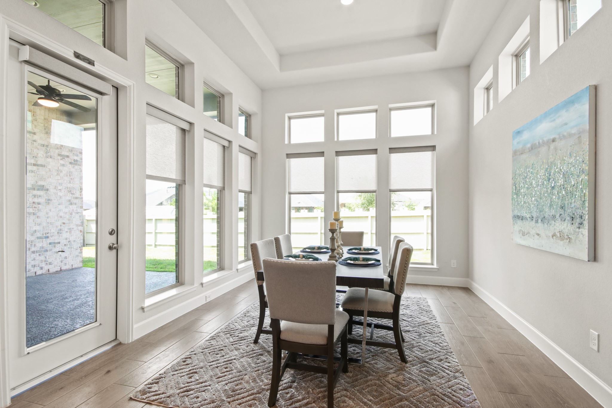 17406 Bayflower Conroe, TX 77385 - Photo 14 of 35 Bright dining area with large windows, modern decor, and wood tile flooring. Ideal for entertaining.