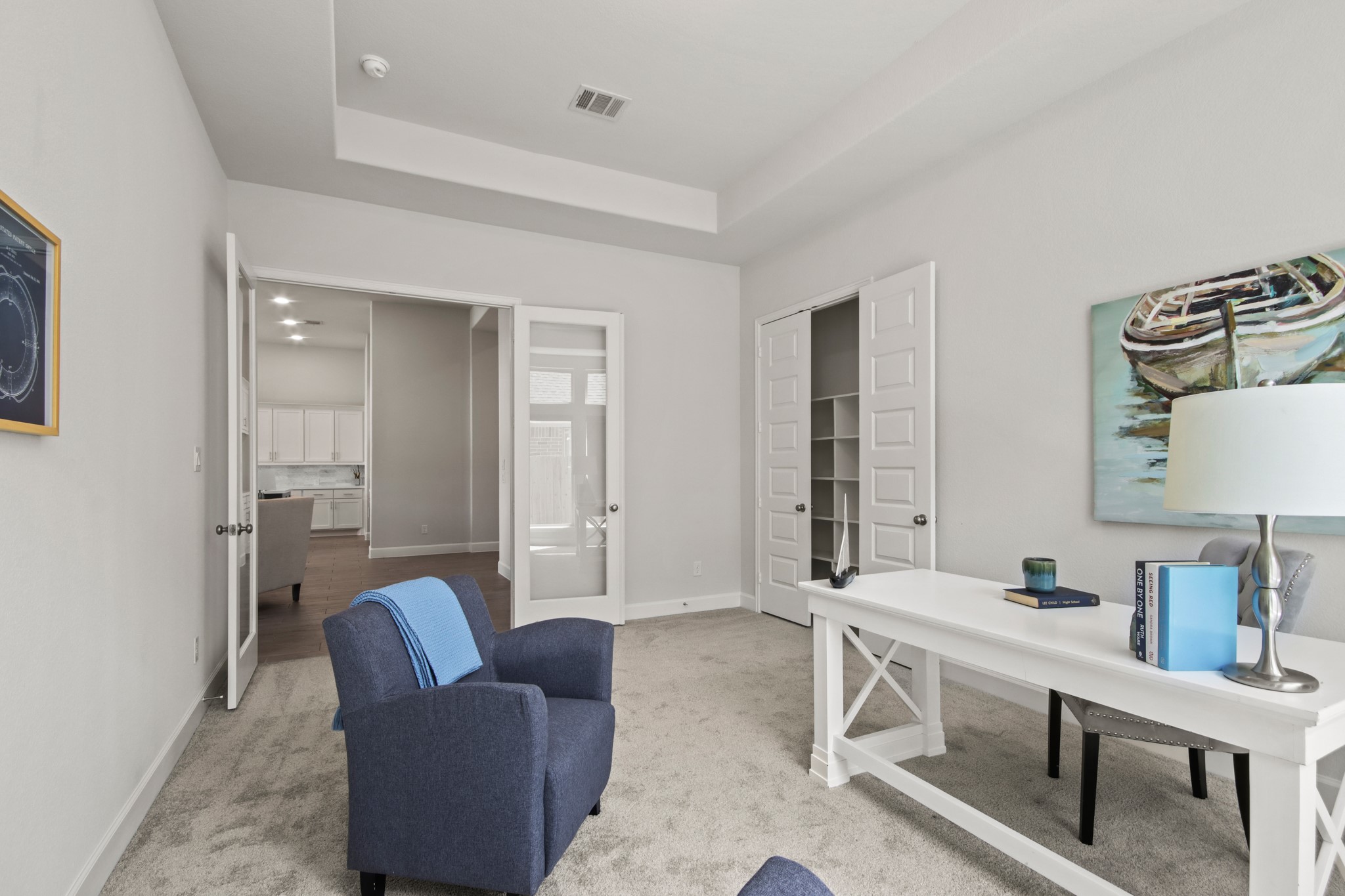 17406 Bayflower Conroe, TX 77385 - Photo 16 of 35 Bright carpeted home office or study with a modern design with double french doors leading to the living area.