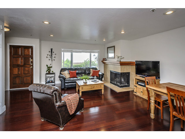 508 Monterey Road, Unit E Pacifica, CA 94044 - Photo 4 of 17 a living room with furniture a flat screen tv and a fireplace