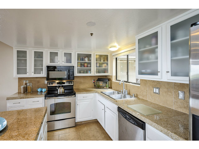 508 Monterey Road, Unit E Pacifica, CA 94044 - Photo 7 of 17 a kitchen with stainless steel appliances granite countertop a sink and stove top oven