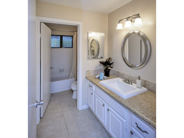 508 Monterey Road, Unit E Pacifica, CA 94044 - Photo 10 of 17 a spacious bathroom with a granite countertop sink and a mirror