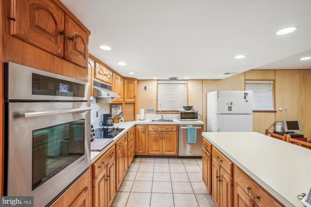 a kitchen with a sink stove and refrigerator
