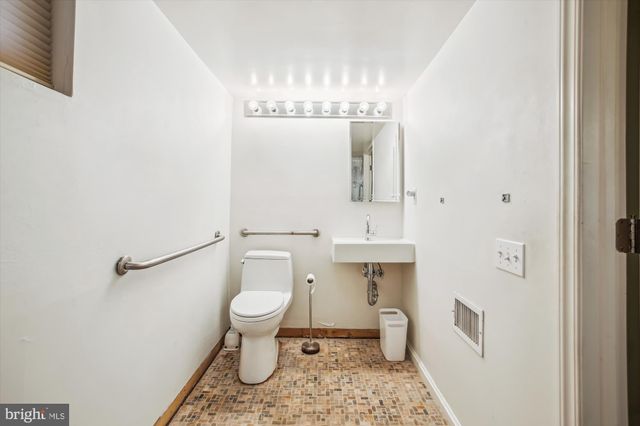 a bathroom with a toilet and a sink