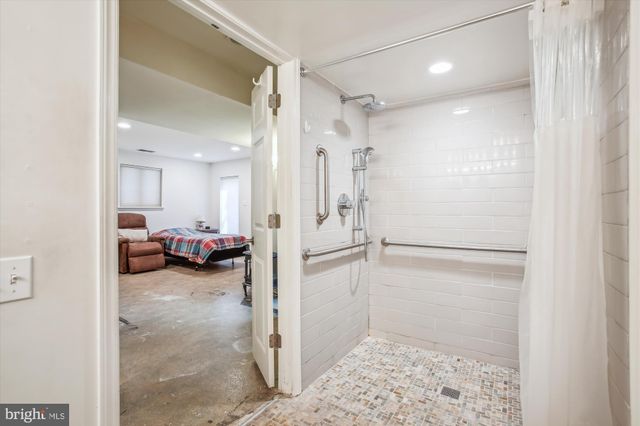 a view of a walk in closet and a bathroom