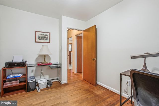 a view of a workspace with furniture and wooden floor