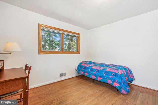 a bedroom with a bed and a lamp on table