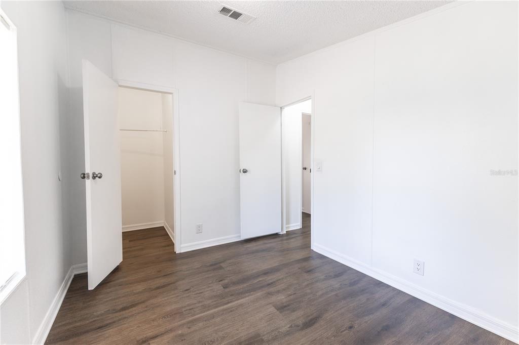 4872 Evans Street Coleman, FL 33521 - Photo 16 of 24 a view of an empty room with wooden floor