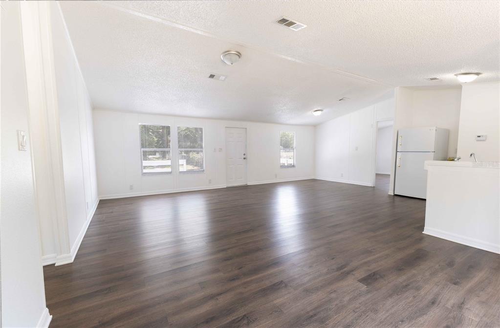 4872 Evans Street Coleman, FL 33521 - Photo 3 of 24 a view of empty room with wooden floor and window