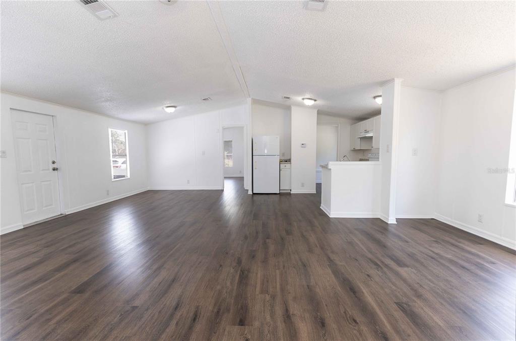4872 Evans Street Coleman, FL 33521 - Photo 5 of 24 a view of empty room with wooden floor and window