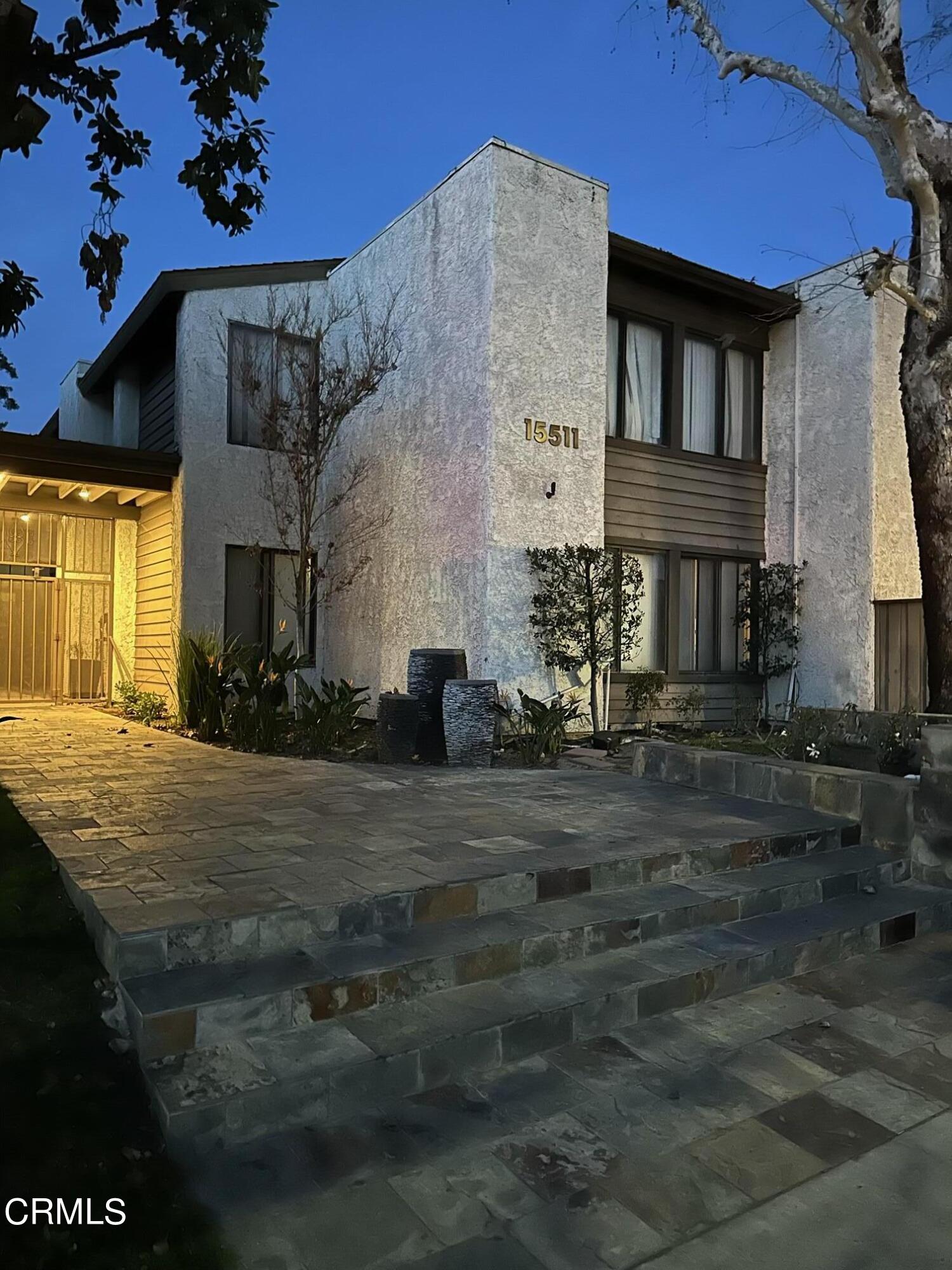 a view of a brick house with many windows