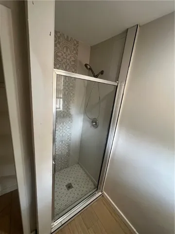 a bathroom with a glass door shower