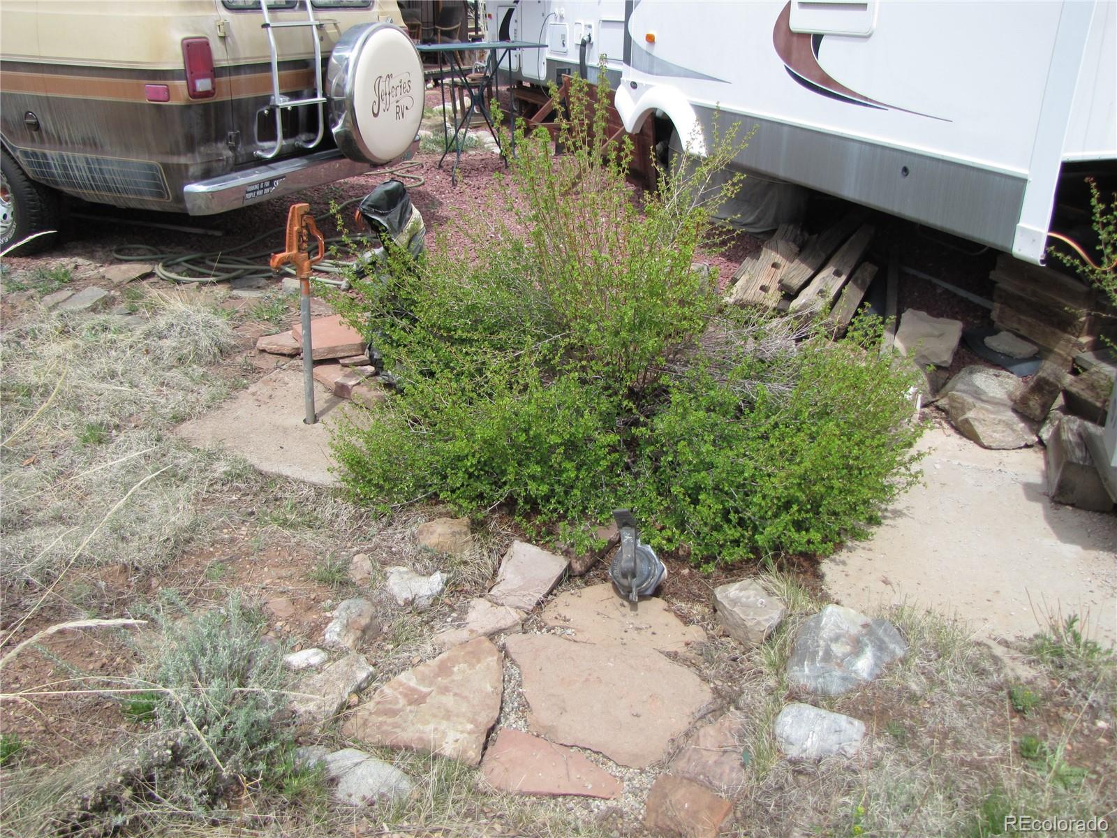 Undisclosed Address Fairplay, CO 80440 - Photo 10 of 11 a backyard of a house with yard fire pit and outdoor seating