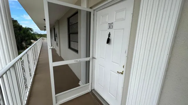 a view of staircase with wooden floor and door