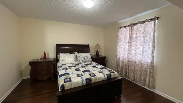 a bedroom with a bed and a window