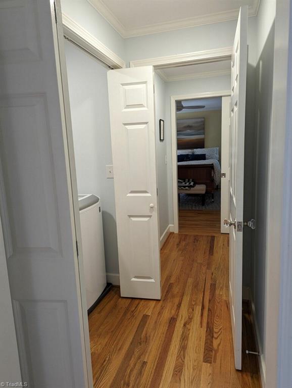 798 Hertford Road Winston-Salem, NC 27104 - Photo 18 of 36 The hallway leading to the primary bedroom suite, laundry is on the left and closet on the right.