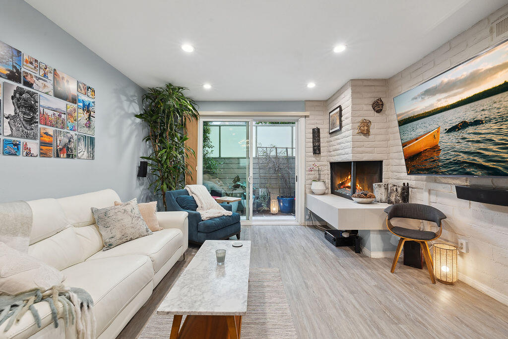 11625 Texas Avenue, Unit 101 Los Angeles, CA 90025 - Photo 1 of 40 a living room with furniture fireplace and a large window