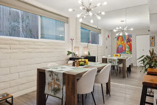 a view of a dining room with furniture and chandelier