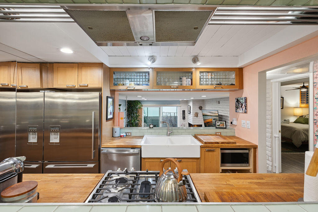 11625 Texas Avenue, Unit 101 Los Angeles, CA 90025 - Photo 15 of 40 a kitchen with stainless steel appliances granite countertop a stove and a refrigerator
