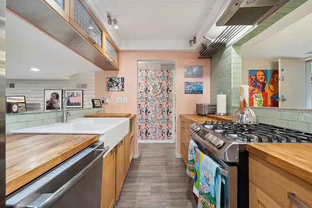 a kitchen with stainless steel appliances granite countertop a stove and a sink