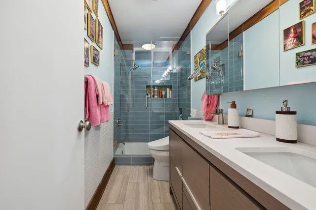 a bathroom with a sink toilet and shower