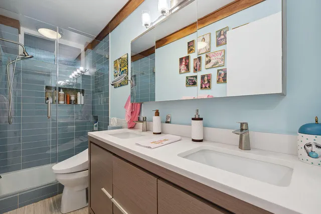 a bathroom with a sink a toilet and shower