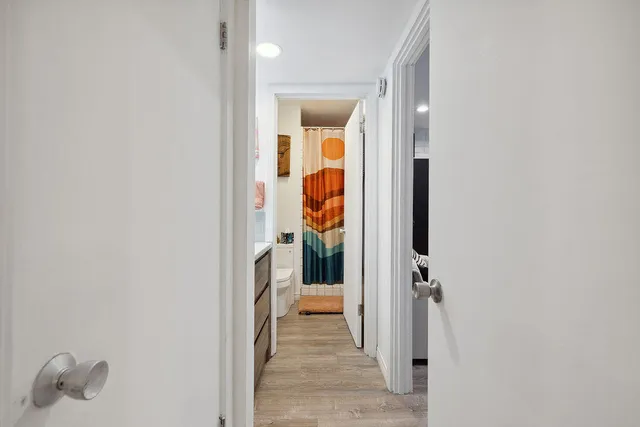 a living room with furniture and a painting on the wall