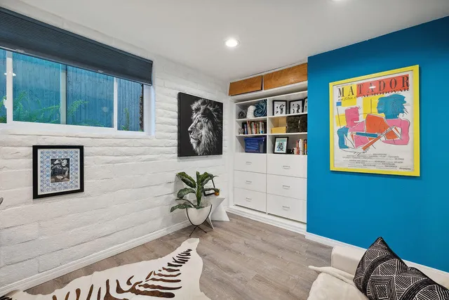a bathroom with a sink and mirror with window