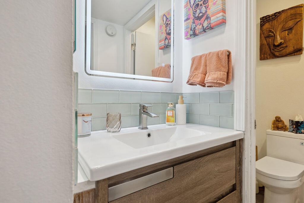 11625 Texas Avenue, Unit 101 Los Angeles, CA 90025 - Photo 33 of 40 a bathroom with a sink a toilet and a mirror