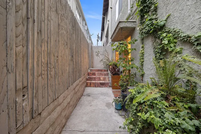 a view of an entrance to house with yard and green space