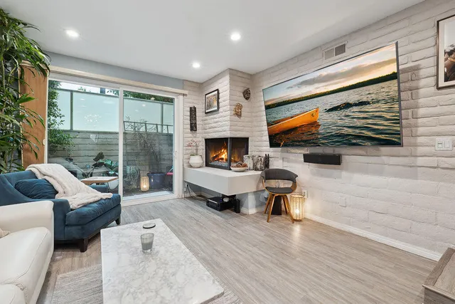 a living room with furniture flat screen tv and a fireplace