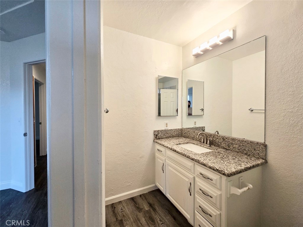 7352 Nada Street Downey, CA 90242 - Photo 20 of 28 a bathroom with a granite countertop sink and a mirror