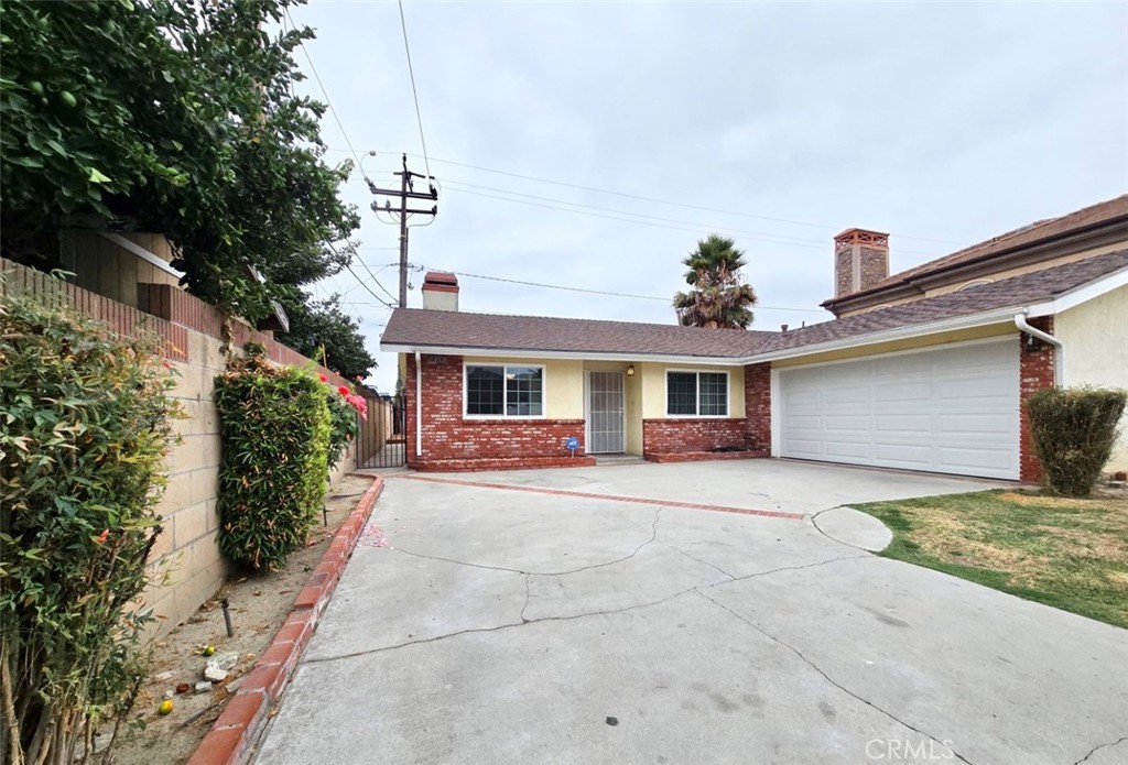 7352 Nada Street Downey, CA 90242 - Photo 2 of 28 a front view of a house with garden