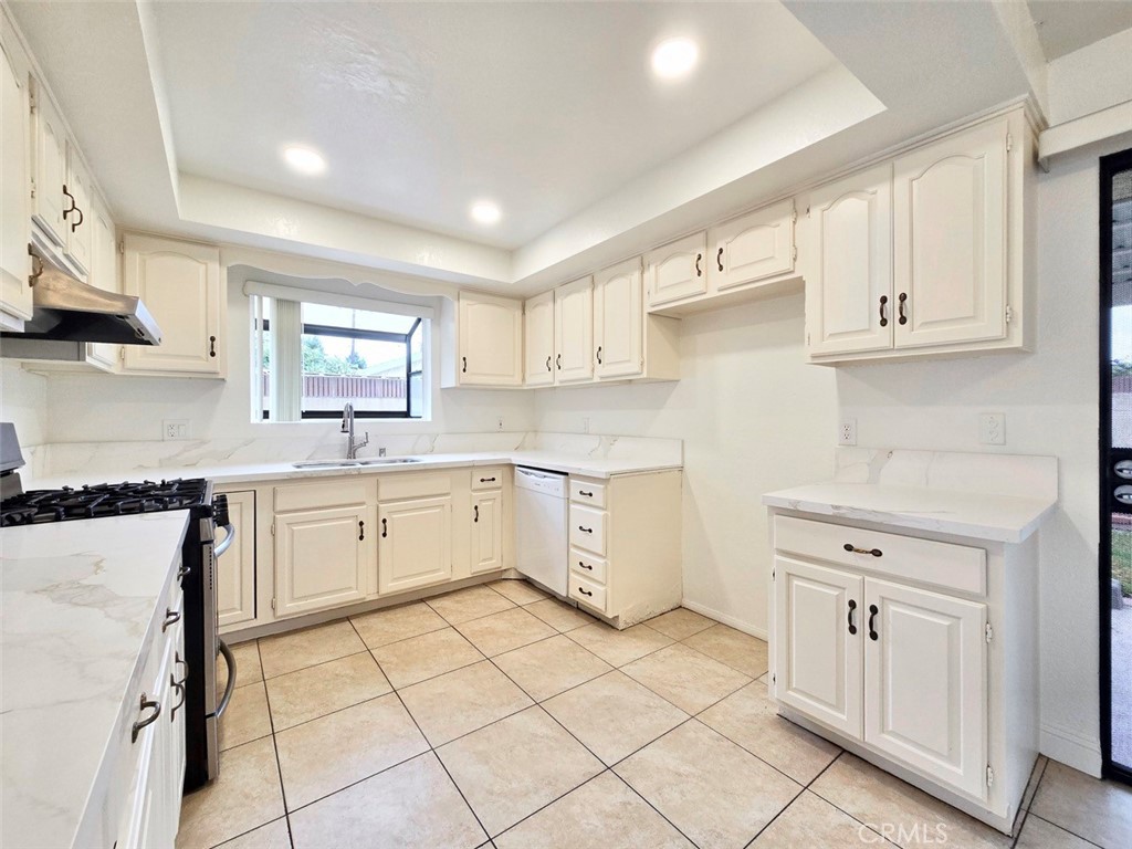 7352 Nada Street Downey, CA 90242 - Photo 5 of 28 a kitchen with cabinets appliances a sink and a counter top space