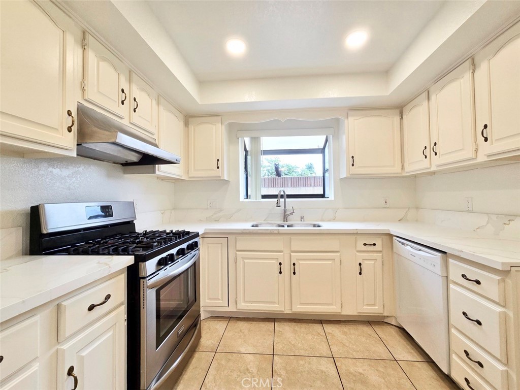 7352 Nada Street Downey, CA 90242 - Photo 6 of 28 a kitchen with cabinets appliances a sink and a window