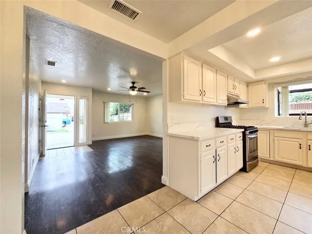 a kitchen with a refrigerator and cabinets