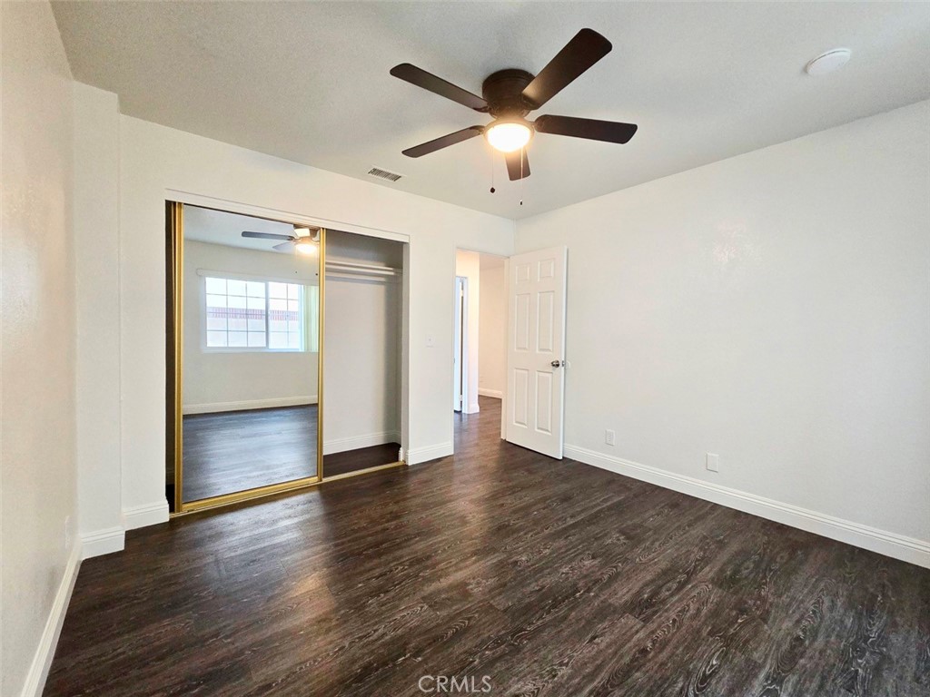 7352 Nada Street Downey, CA 90242 - Photo 10 of 28 an empty room with wooden floor and windows