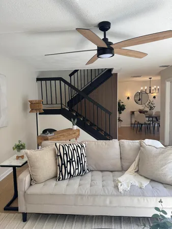 a living room with furniture and a wooden floor