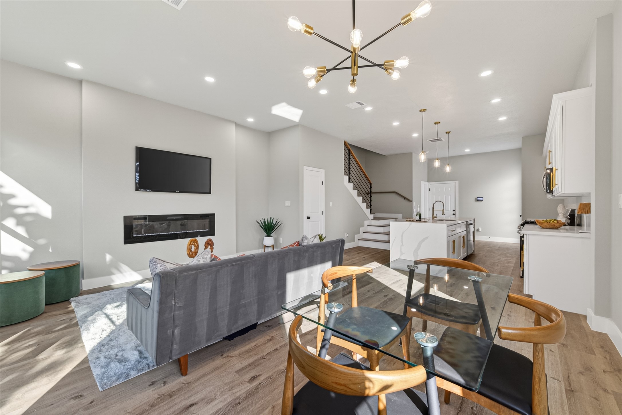 4117 Yale Street Houston, TX 77018 - Photo 21 of 37 a living room with furniture a flat screen tv and kitchen view